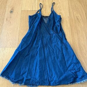 Women’s size S denim mini dress with fringe detail and zipper back.